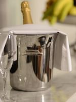 Champagne bucket with flute glasses on a marble counter in Executive Suite at Warwick Stone 55 - Beirut