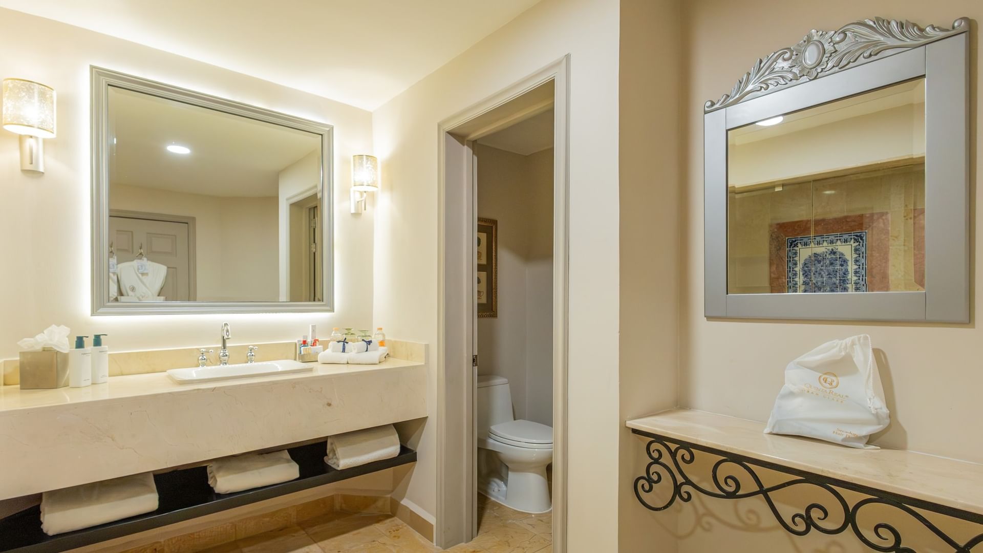 Baño elegante con doble lavabo, espejos enmarcados y toallas blancas en Quinta Real Monterrey, San Pedro Garza García