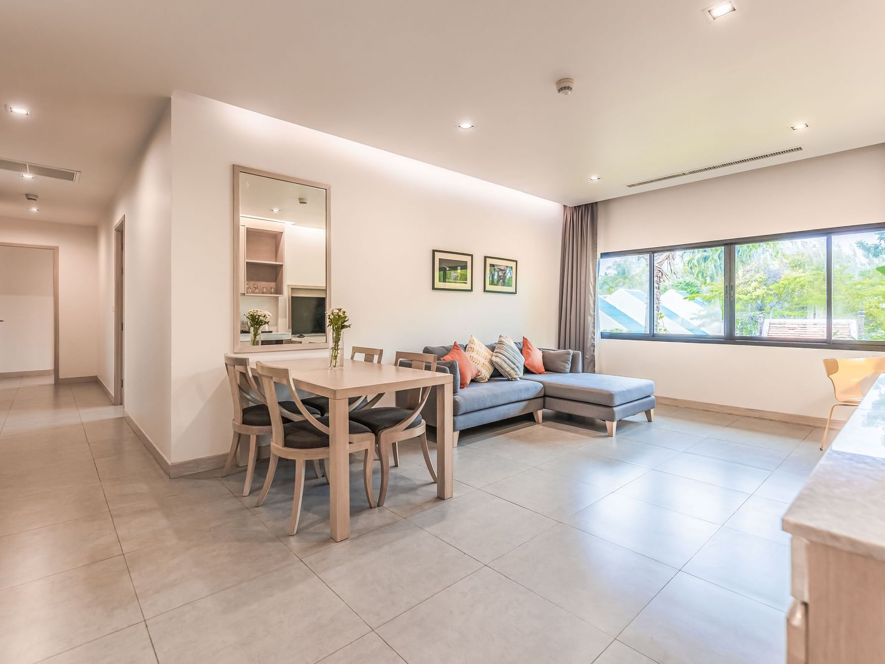 Living room with cozy sofa, table, and walkway to bedrooms