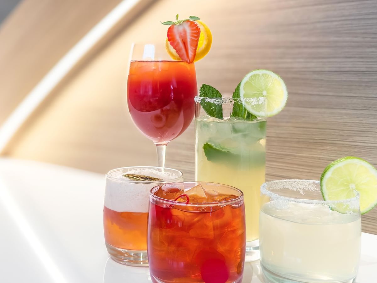 Assorted cocktails with garnishes.