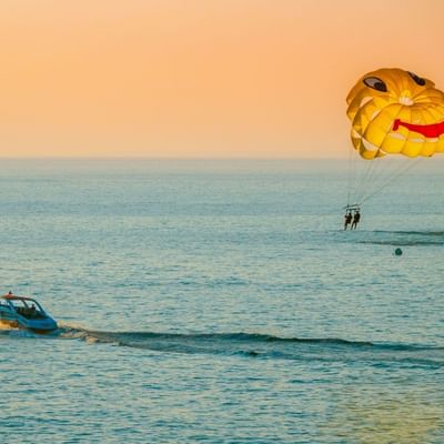 Tourists engaged on parasailing near Falkensteiner Hotels