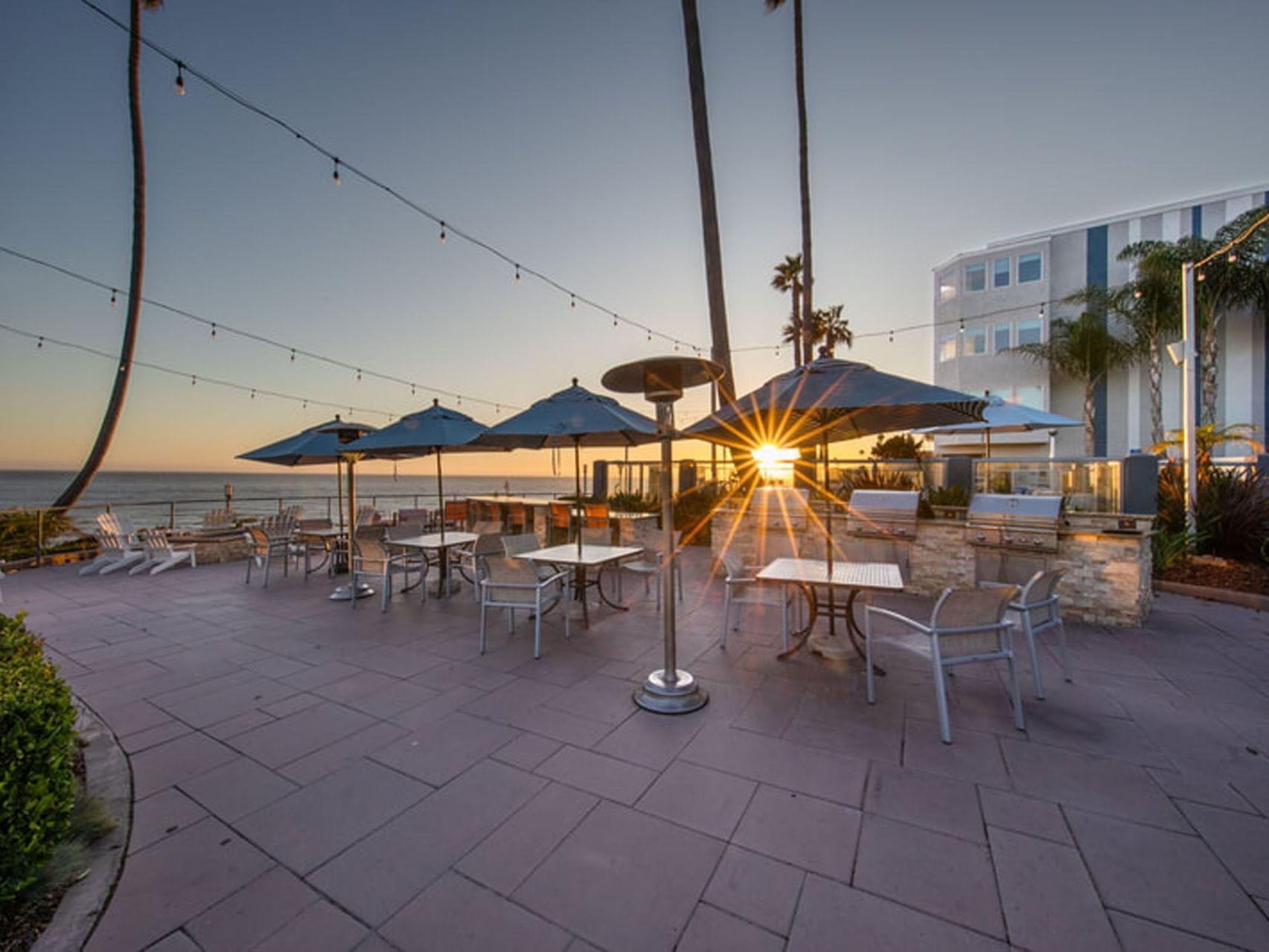 Seamist Terrace at sunset with a cozy seating area in SeaCrest Oceanfront Hotel Pismo Beach