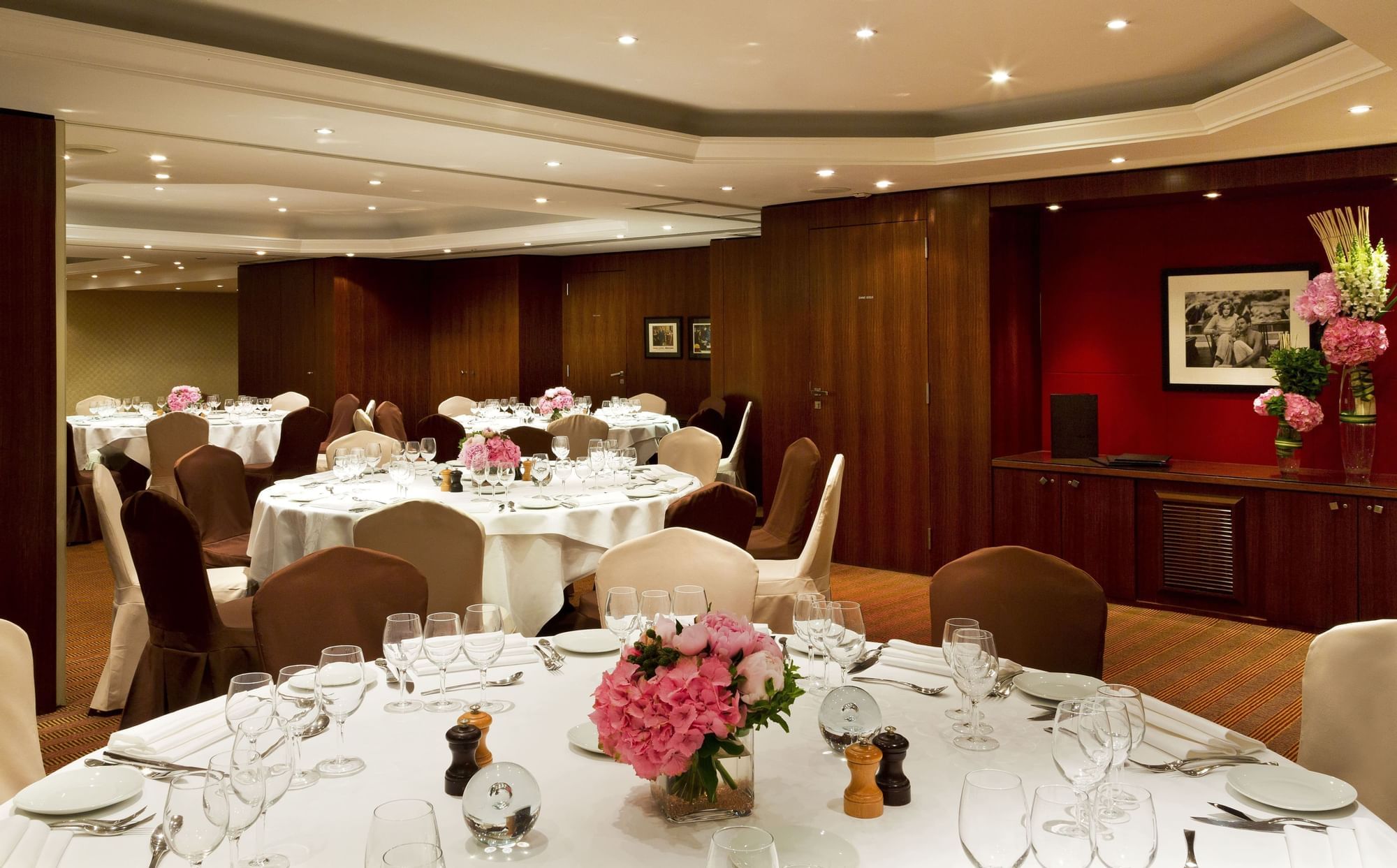 Banquet tables with flower vases in a Hall at Warwick Paris Champs Elysées