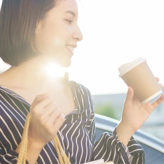 A lady holding a coffee cup at Warwick Le Crystal