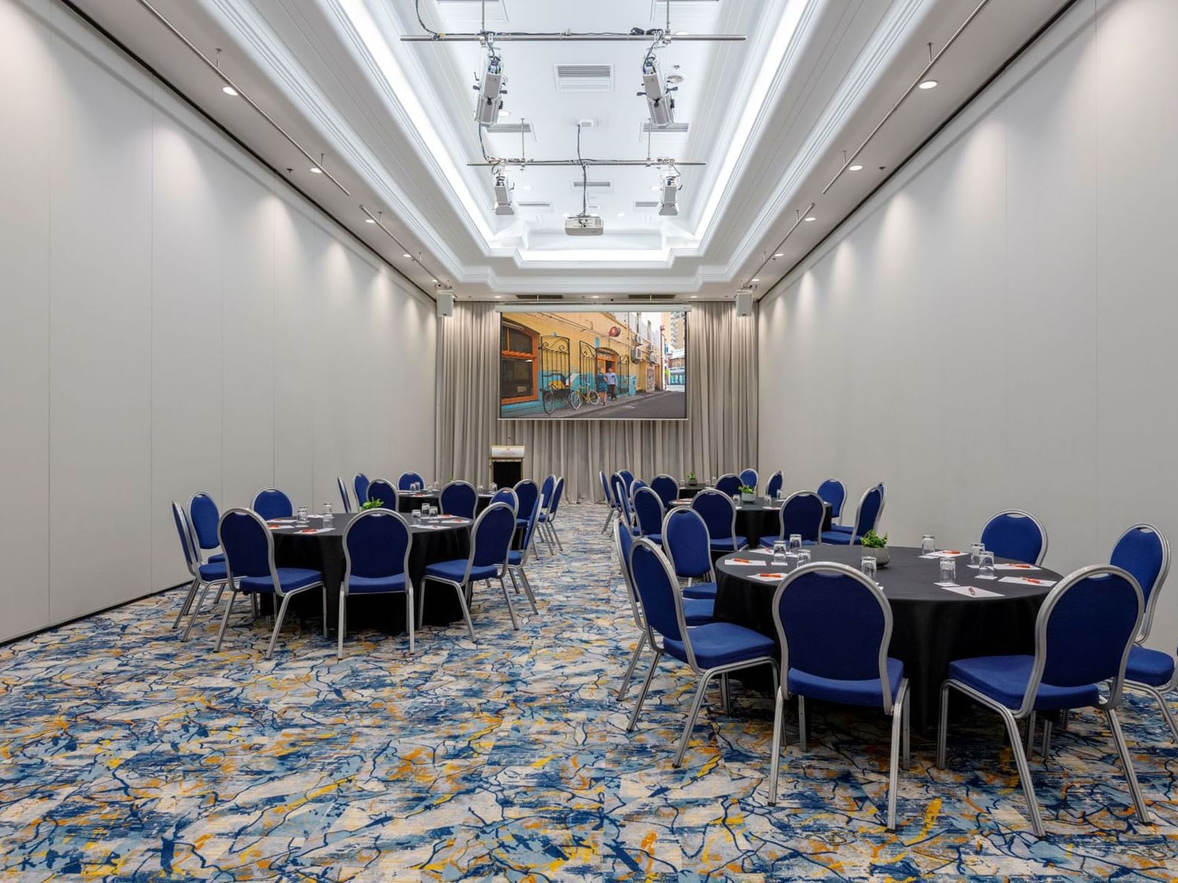 Banquet table set-up with a projector in Hindley 2 at Hotel Grand Chancellor Adelaide