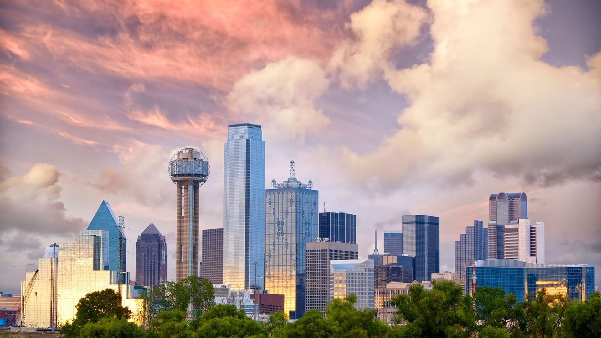 Dallas skyline at sunset, featuring iconic buildings like the Reunion Tower near Warwick Hotels and Resorts