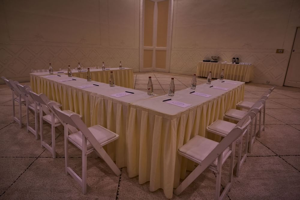 Evening Ixtac Venue featuring a U-shaped table with water bottles and notepads at Quinta Real Acapulco