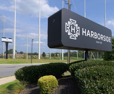 Entrance sign board with garden area at Harborside Hotel