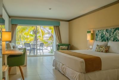 King bed, lounge & balcony in Sea view Room at Playa Blanca Beach Resort