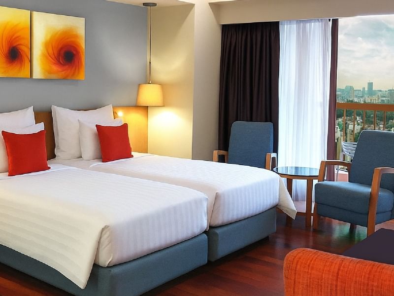 Bright Balcony Studio Twin room at Sunway Hotel Pyramid, featuring two beds and a balcony with city views