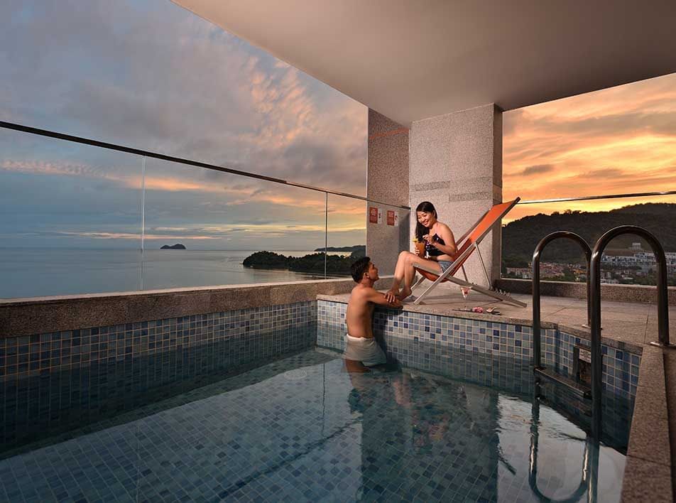 couple enjoying time in a private pool with panoramic views of the sunset