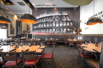 Dining tables arranged in Pacini restaurant near Acclaim Hotel Calgary