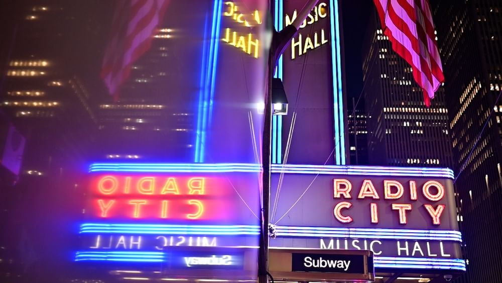 Neon signs for Radio City Music Hall and City Hall in New York City.