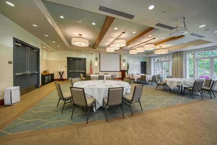 Olympic Ballroom with banquet tables & warm ambience arranged at Alderbrook Resort & Spa