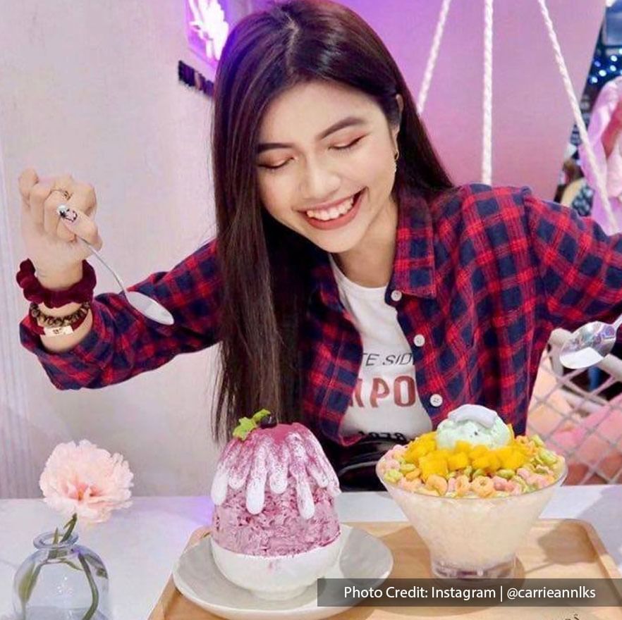 A woman posing with kakigori shaved ice at Mykori Dessert Cafe, Port Dickson