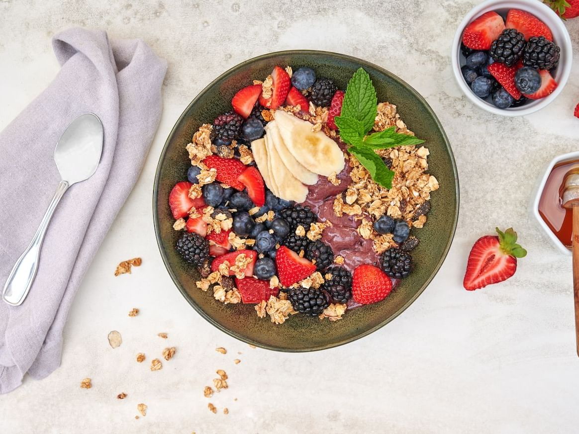 Close-up of a cereal bowl served with berries and toppings at Luxe Sunset Boulevard Hotel