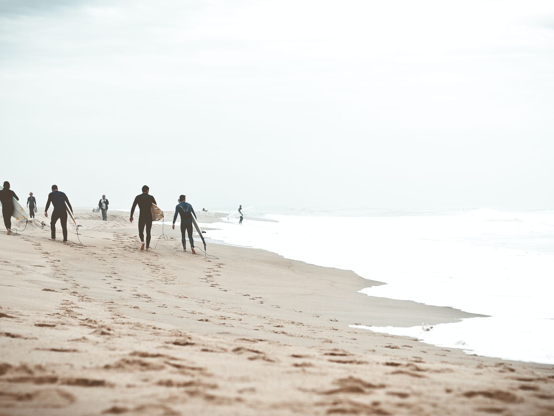 Group of surfers at the beach near The Rockaway Hotel