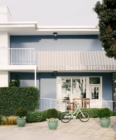 Hotel exterior with balcony and bicycle