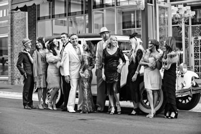 People posing in front of a vintage car at Horton Grand Hotel