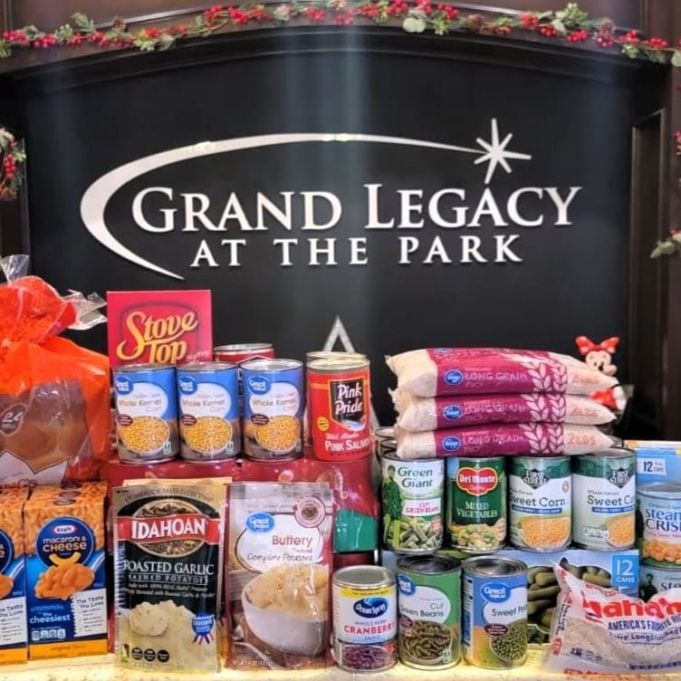 Thanksgiving Food Drive at Grand Legacy At The Park showcasing the food collecting at our hotel front desk. 