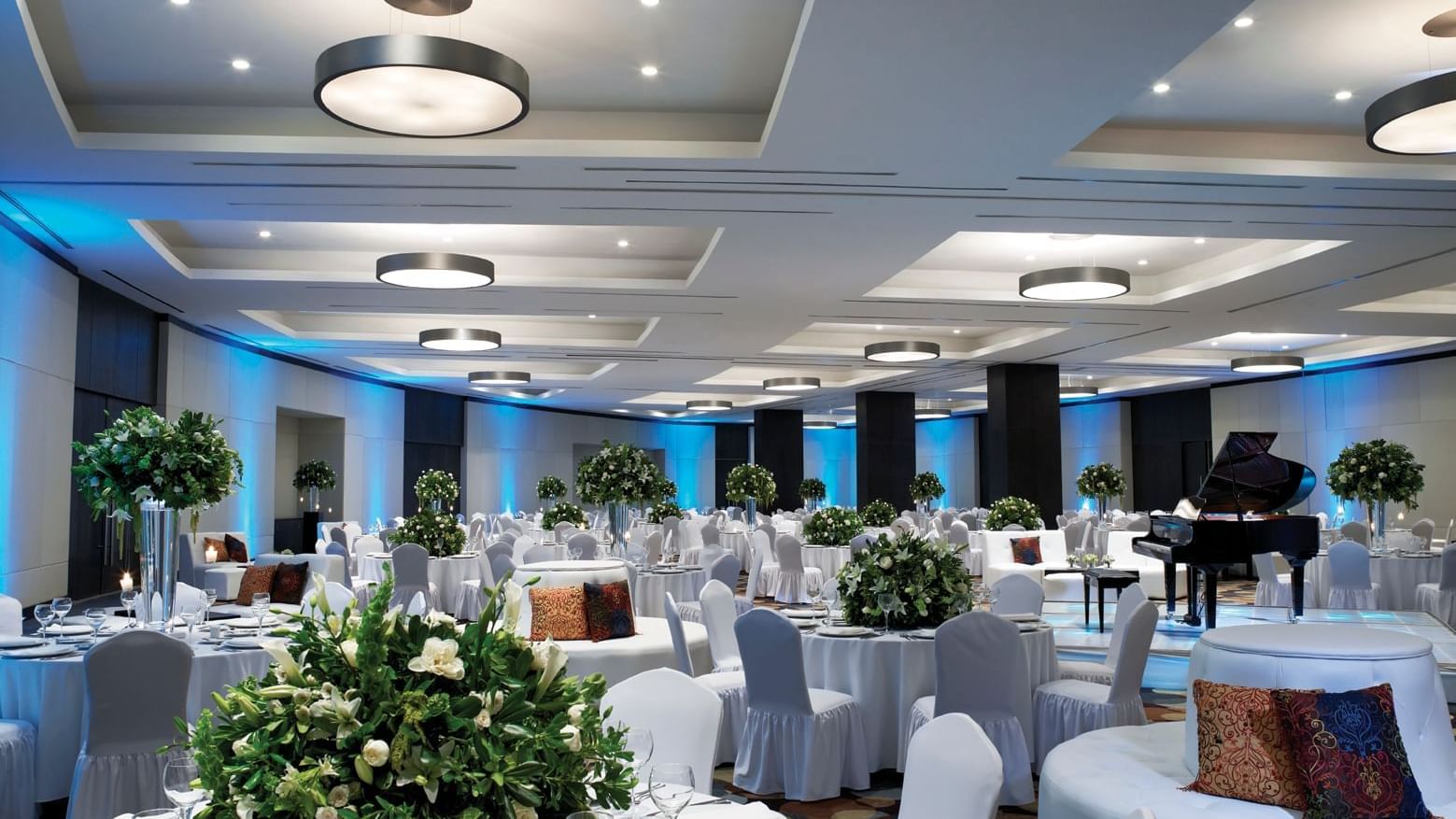 Banquet table set-up in a wedding hall with floral deco and carpeted floors at Live Aqua Resorts and Residence Club