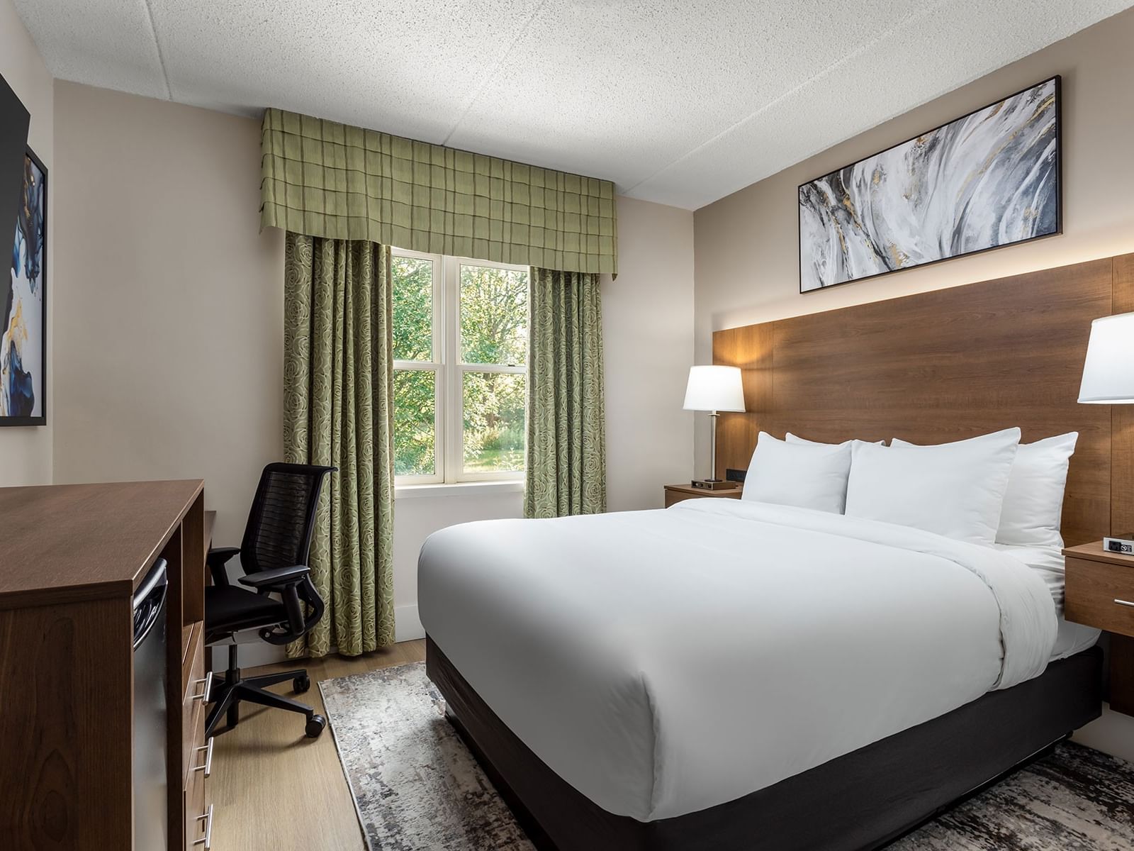TV with work desk facing bed by window in 1 Queen Bed Mobility Accessible Heritage Room at Spencer Hotel