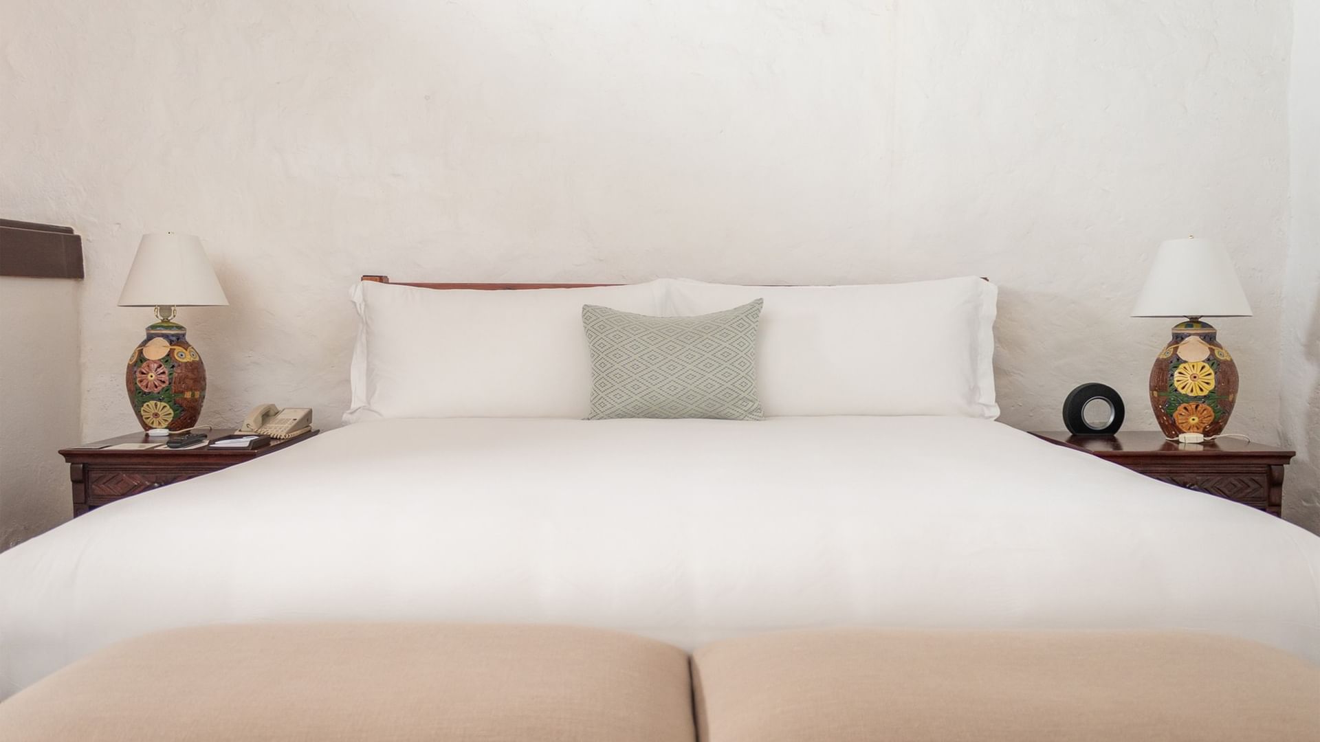 Suite Gobernador King con cama grande, almohadas, mesitas de noche y lámparas en Quinta Real Oaxaca