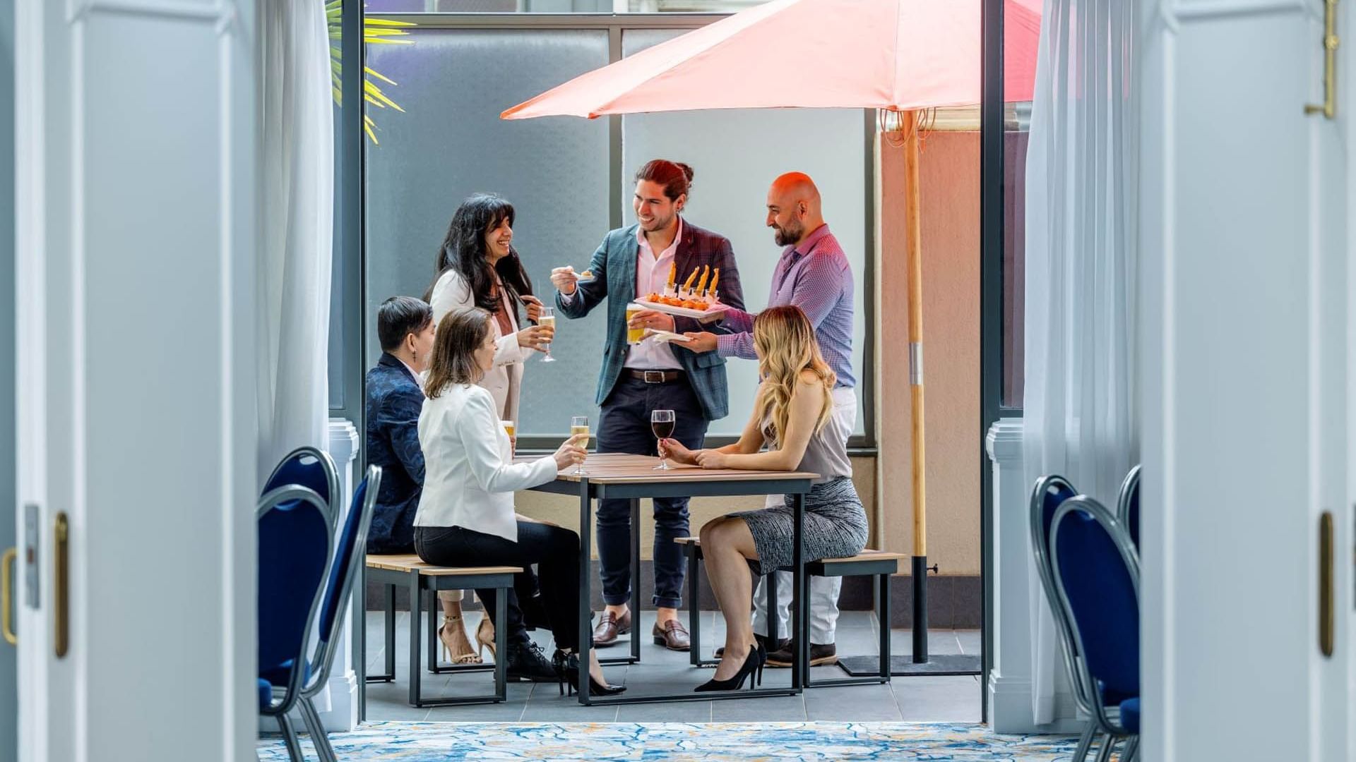 People dining & lounging in Torrens Balcony cocktail catering at Grand Chancellor Adelaide