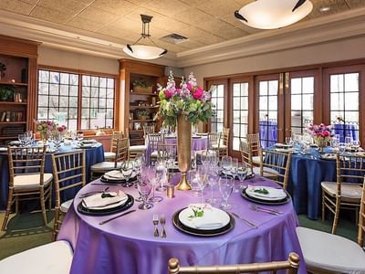 Elegant banquet hall set up with beautiful purple table linens at The Boulevard Inn & Bistro