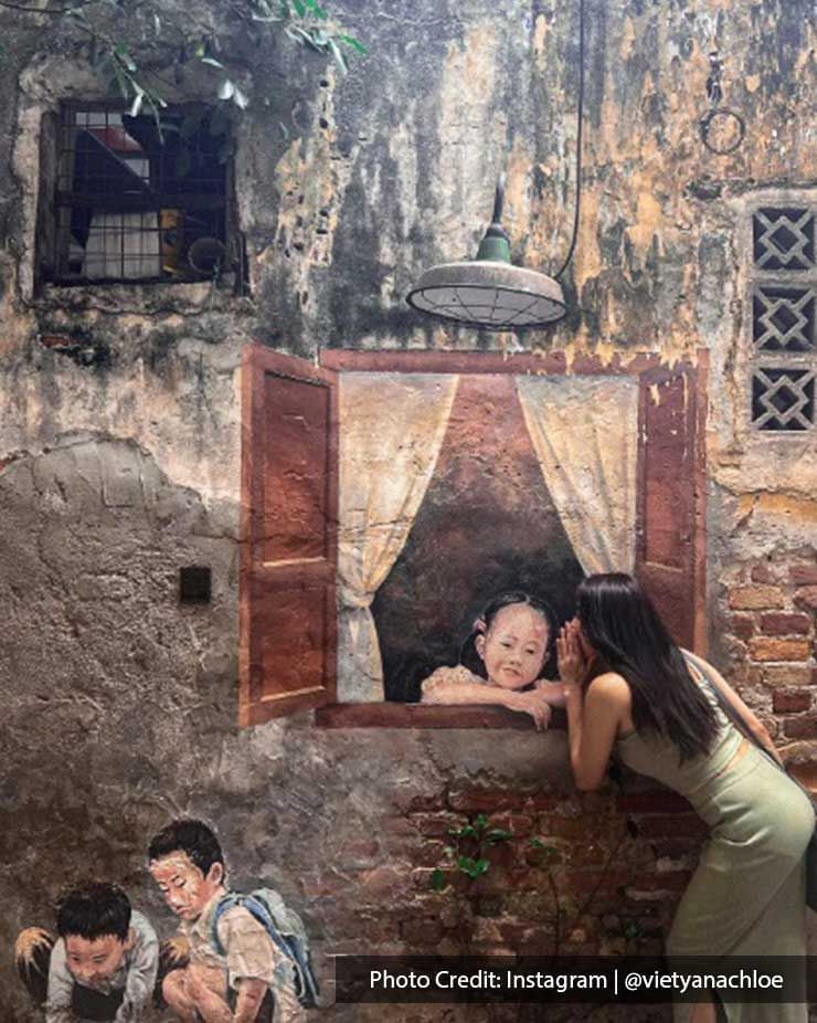 Lady posing by wall art in Kwai Chai Hong, a place with tourist attractions near Imperial Lexis Kuala Lumpur