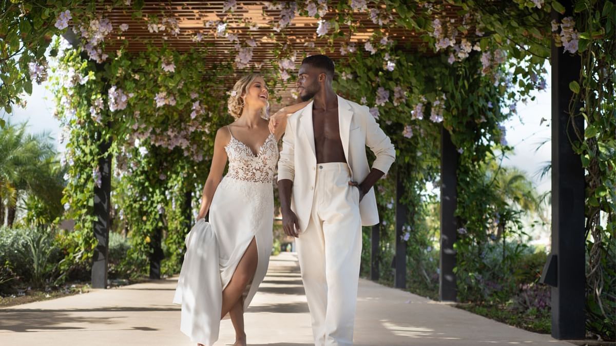 A couple walking down a decorated path at Live Aqua Resorts