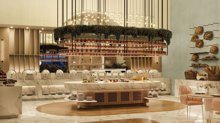 Marble buffet island by stacked plates under a hanging garden in The Med at Cantonal Hotel by Warwick Riyadh