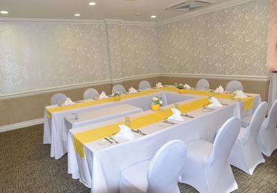 Conference table and chairs arranged for an event in Windsor Suite at Courtleigh Hotel & Suites