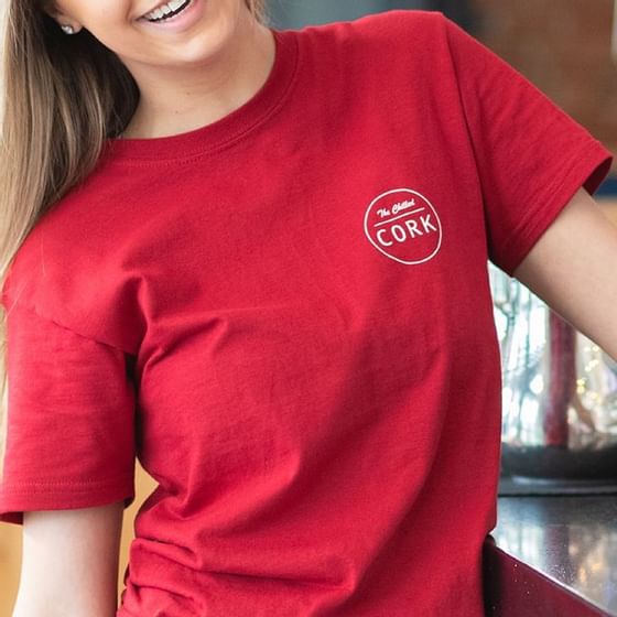 A lady wearing a red t-shirt with The Chilled Cork logo at Retro Suites Hotel