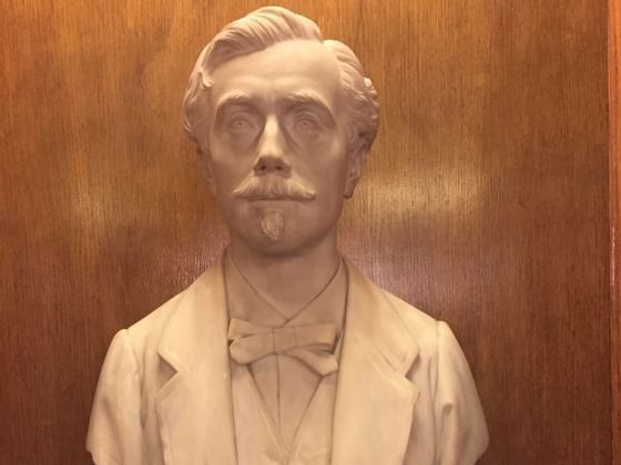 Close-up of a marble bust of a man in a room at Bettoja Hotels Group