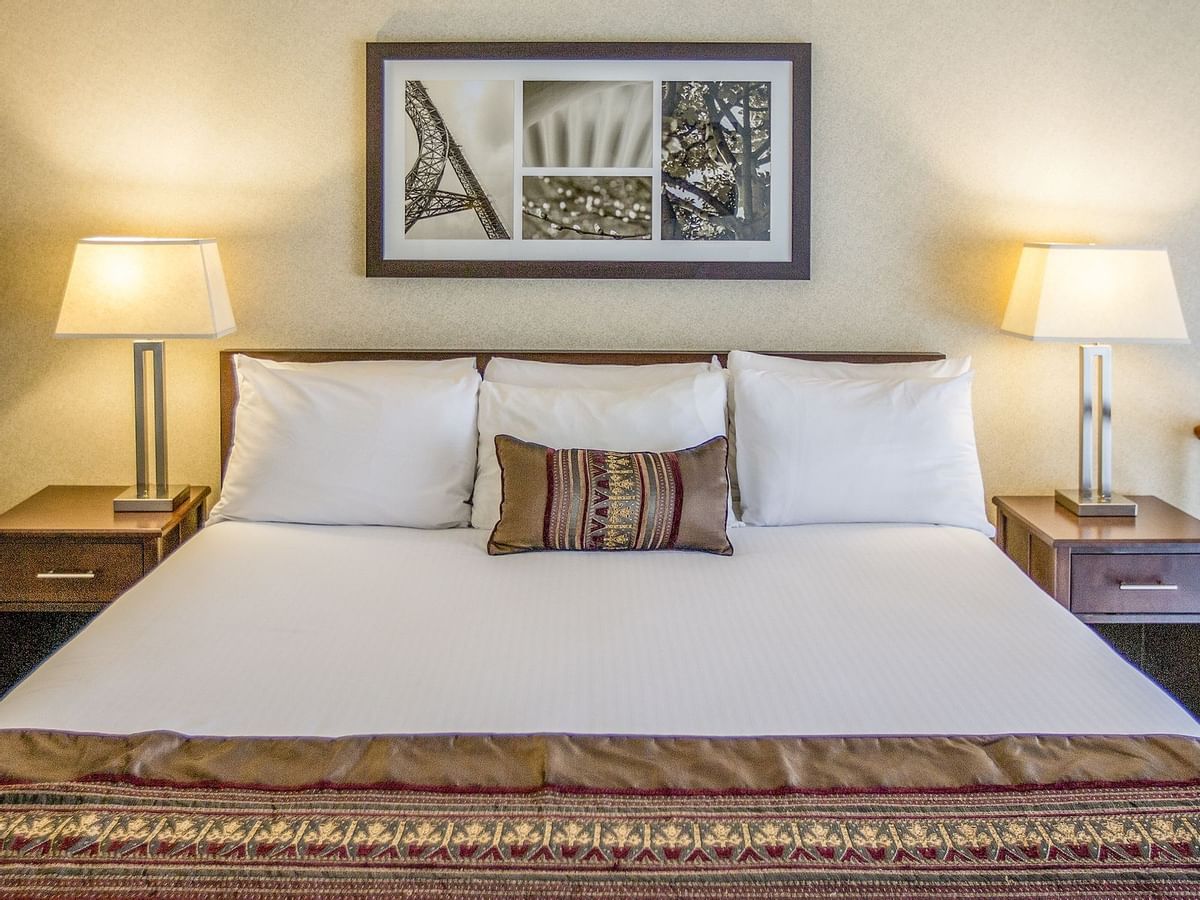 King bed in modern hotel room with artwork