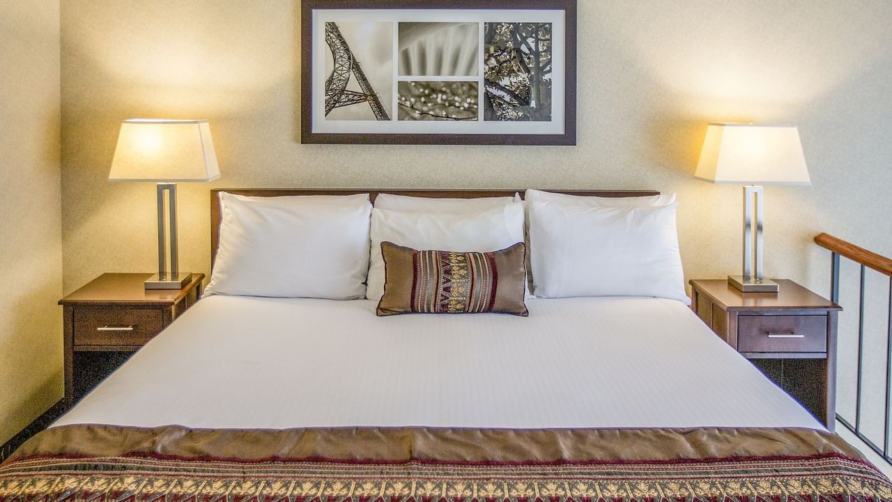 King bed in modern hotel room with artwork