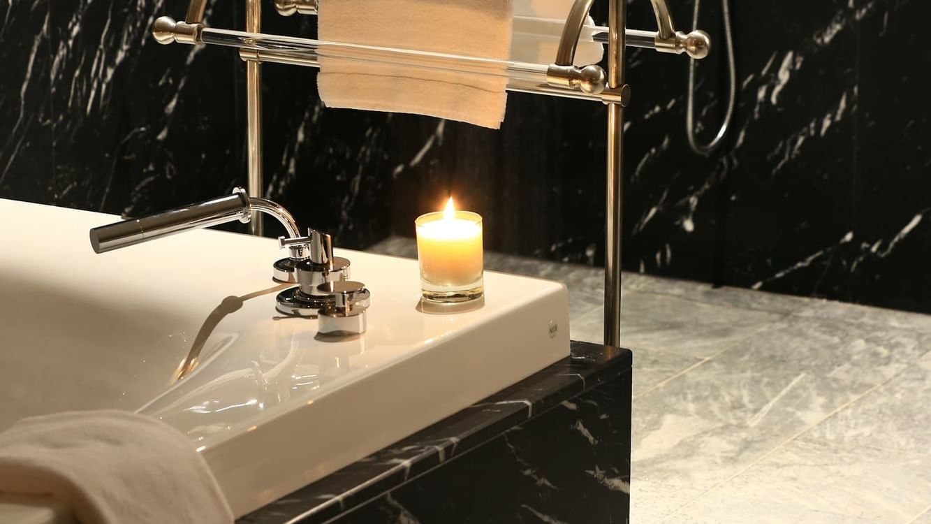 Bathtub with towel rack & a candle, Spa at Domaine de Manville