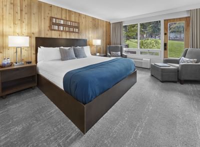 Pool Facing Deluxe King with cozy bed and sofa at Fairmont Hot Springs Resort