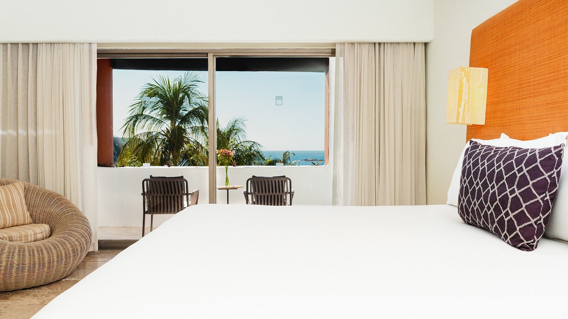 Cozy lounge chair by the bed in King Suite Private Pool with private balcony seating at Camino Real Zaashila Huatulco