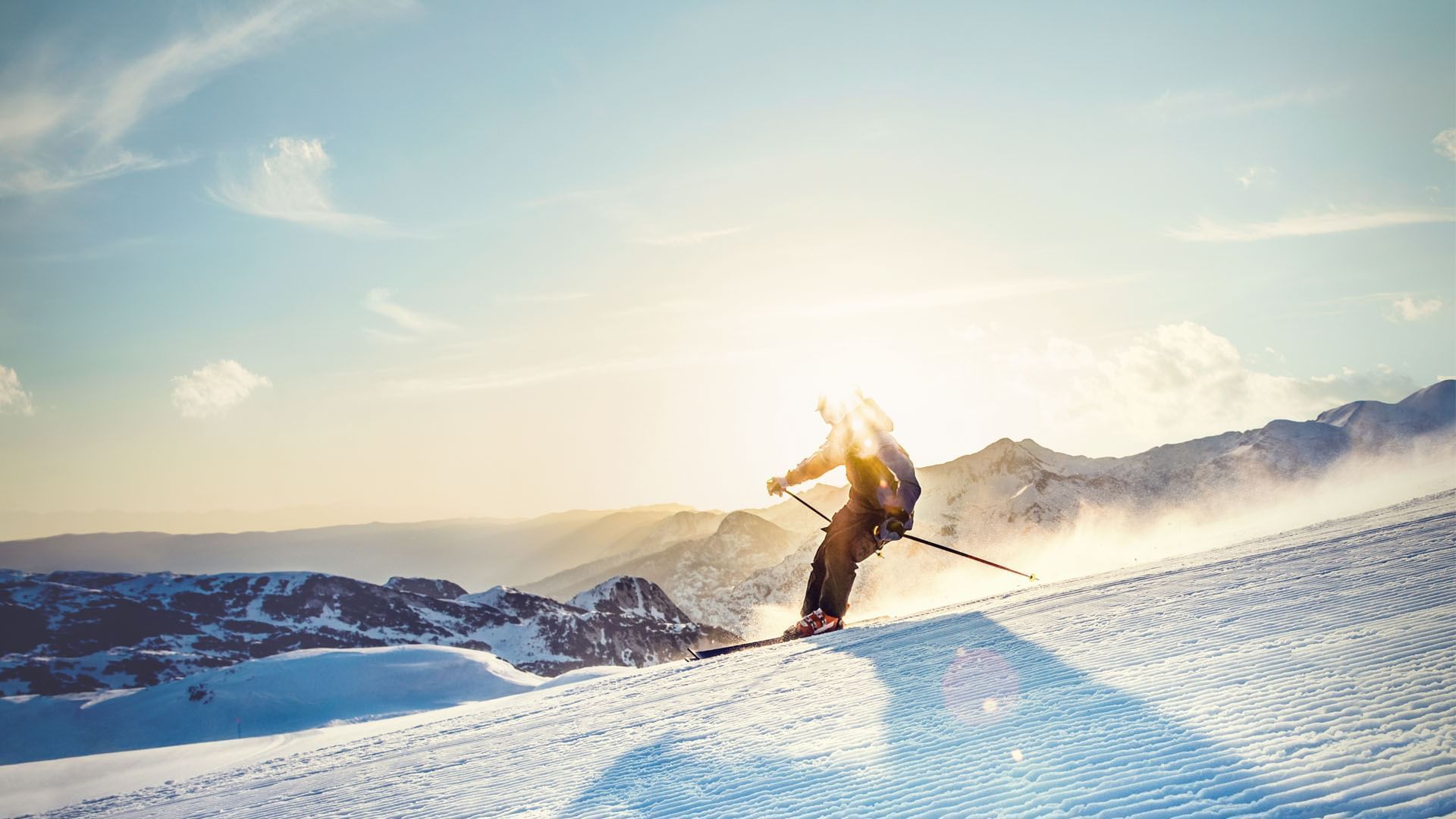 A man skiing down in a snowy mountain at Falkensteiner Hotels