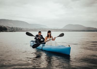 Couple Kayaking in Wedding Attire