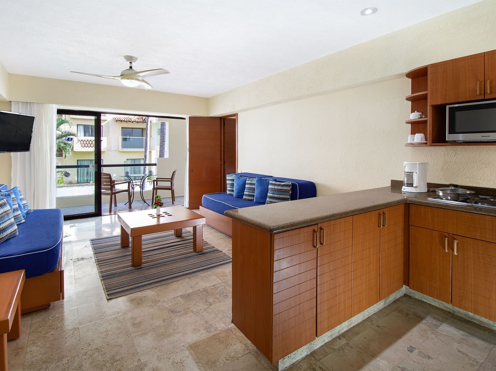 TV lounge area with kitchenette in 1 Bedroom Suite at Plaza Pelicanos Grand Beach Resort