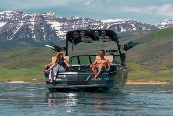 Couple relaxing on a boat in Deer Creek Reservoir at The Chateaux Deer Valley