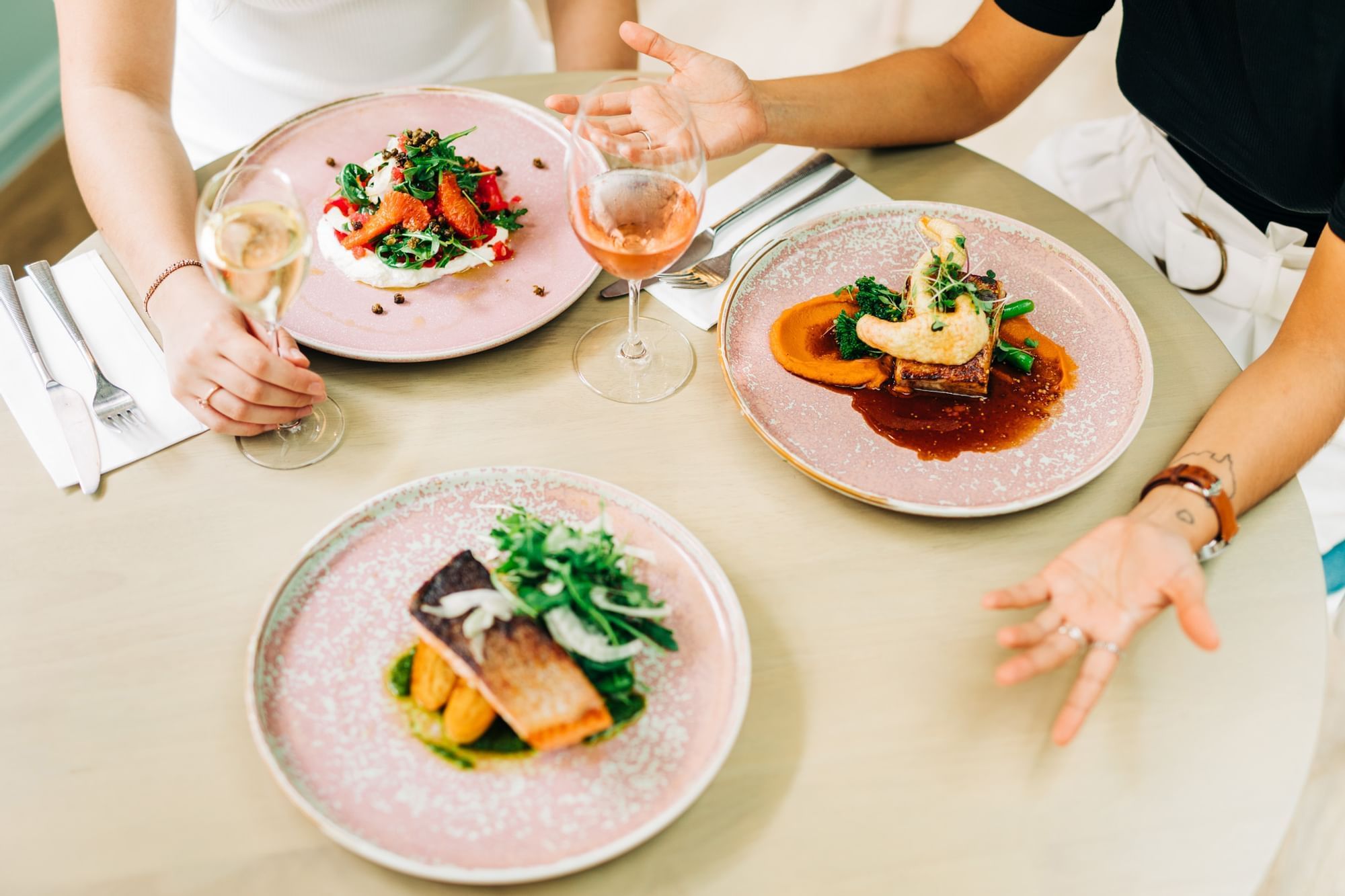 A couple dining at a table with plates of food in a restaurant at Pullman King George Square