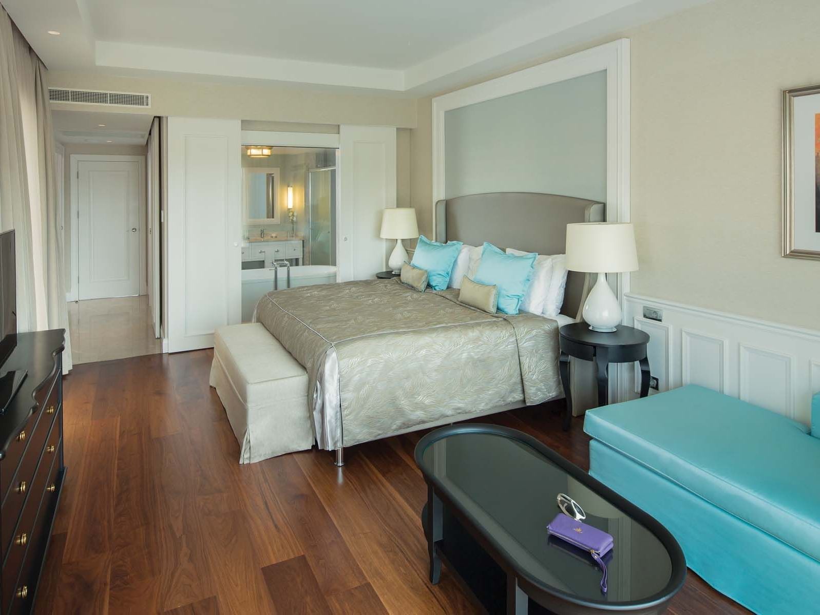 Sitting area by the bed in Design Pool Villa with wooden floors at Titanic Deluxe Golf Belek