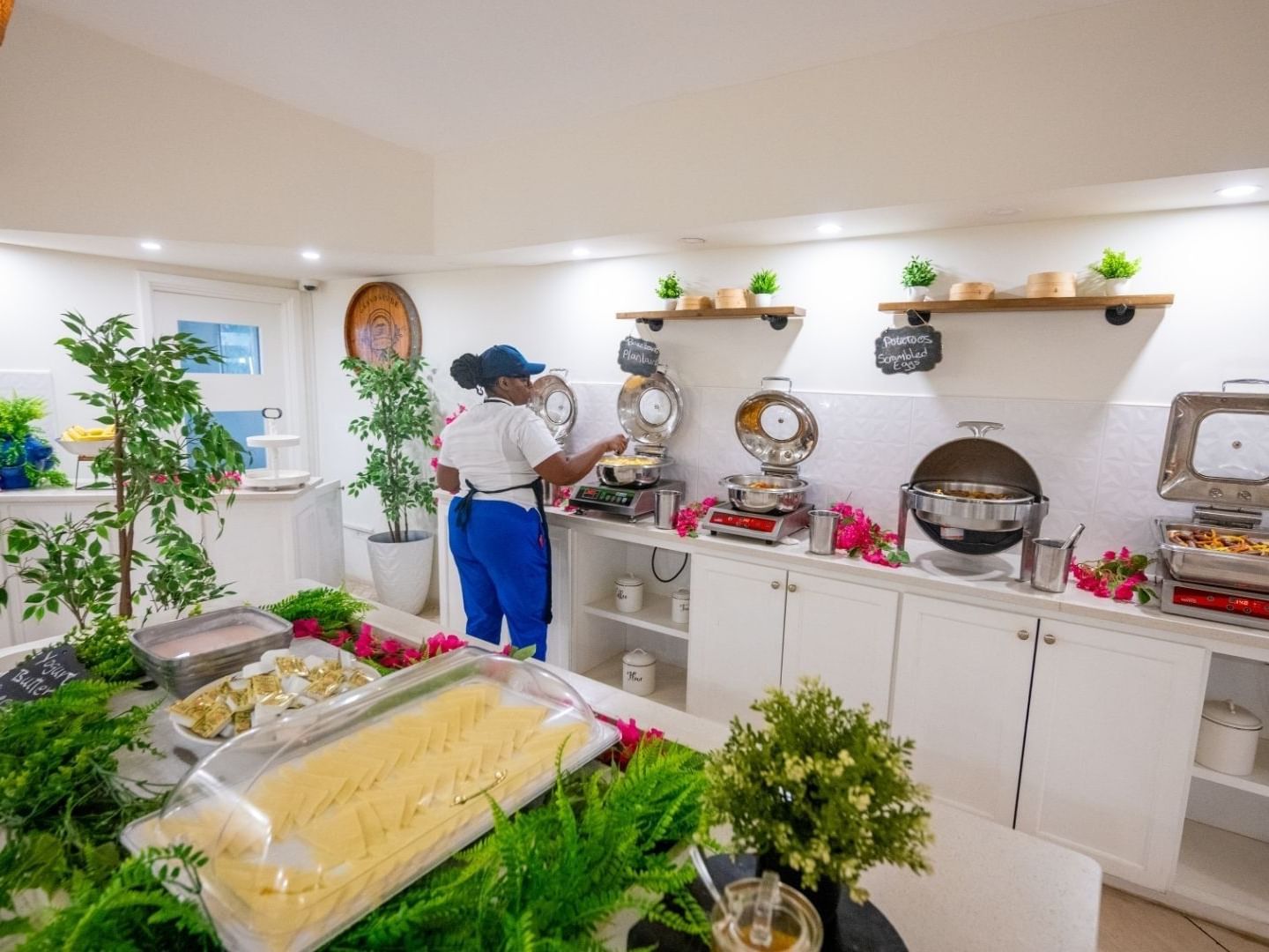 Staff arranging food on a buffet line at Savannah Beach Hotel.