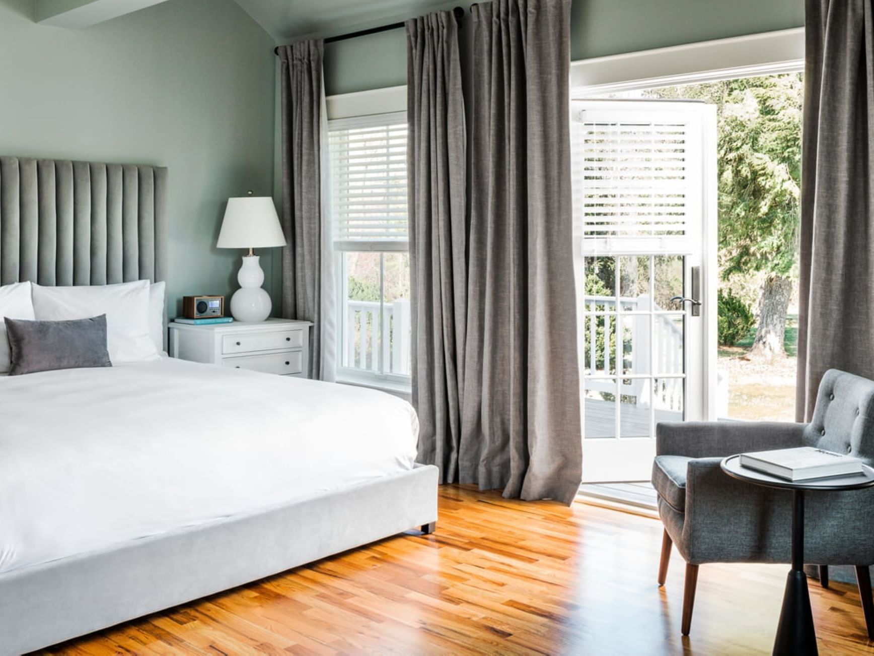 Cozy king bed, nightstand & lounge in Dogwood Room at The Clifton