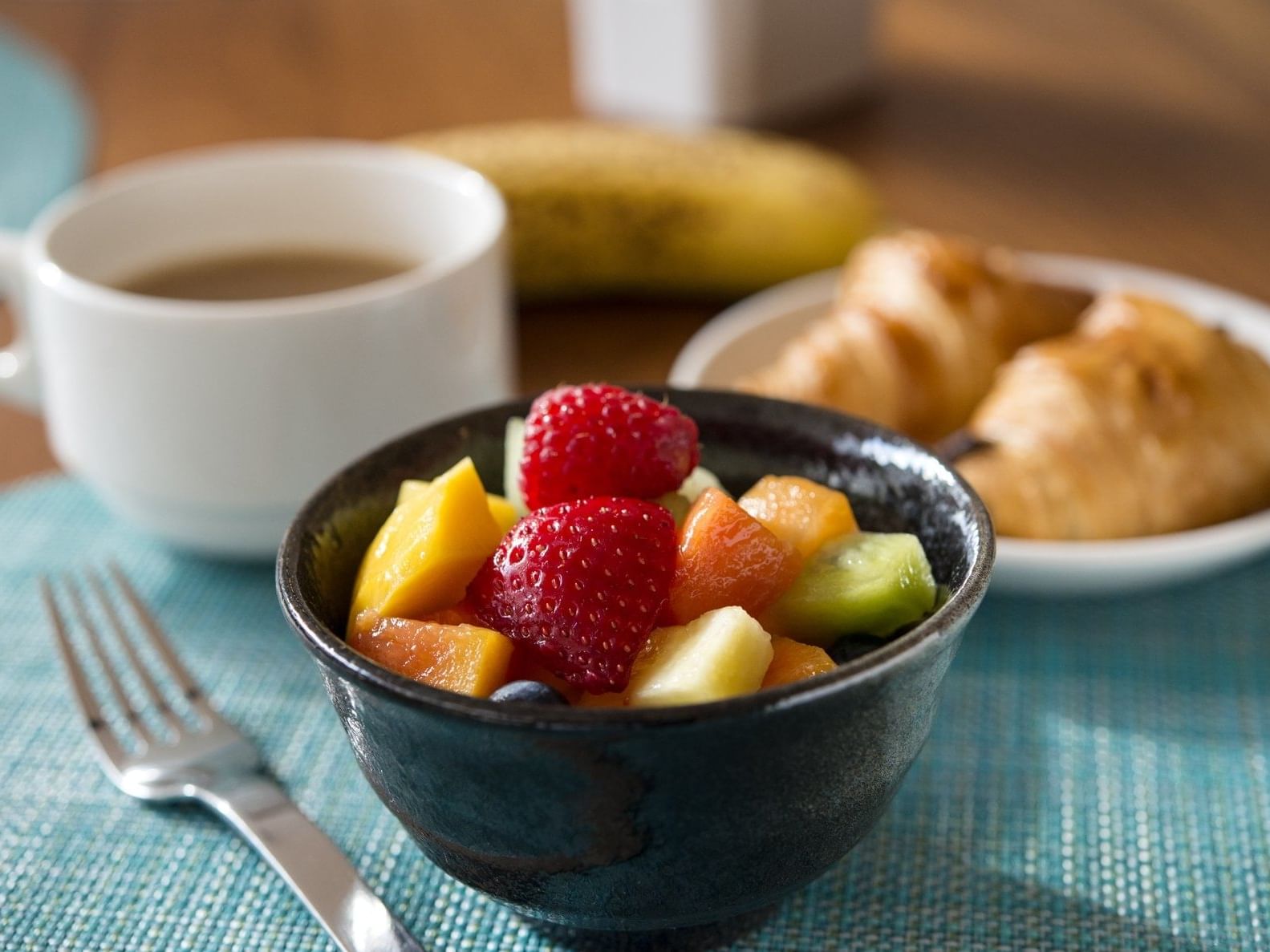 A fruit dish & croissants with tea served at Plymouth Hotel