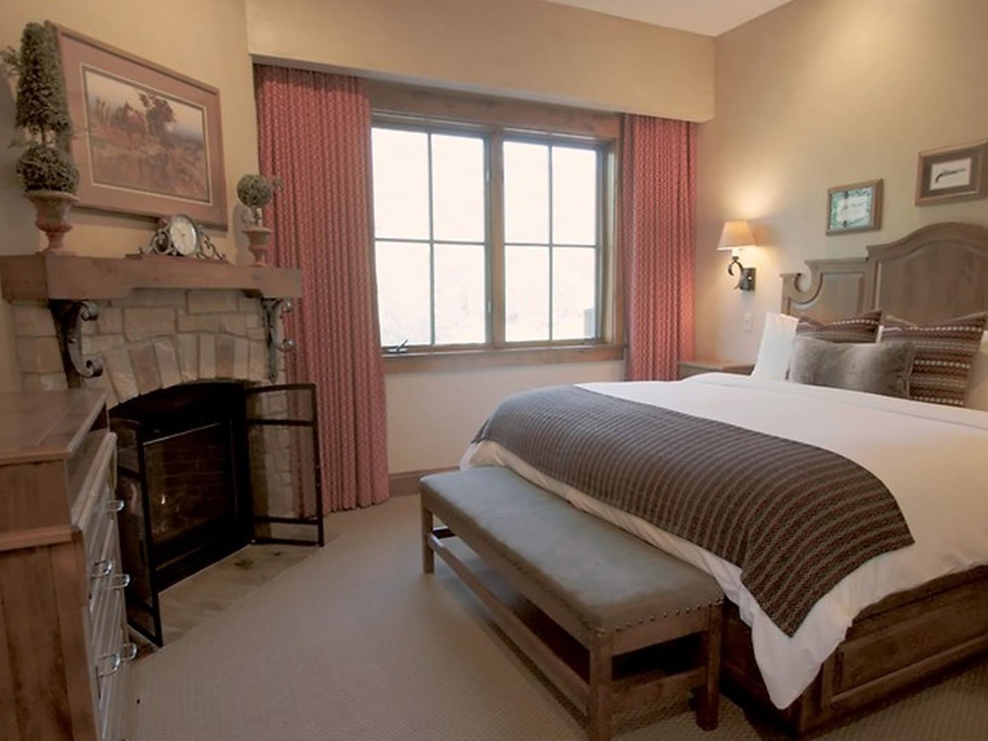 Governor's Suite featuring cozy bed, stone fireplace & large window at Hotel Park City Autograph Collection